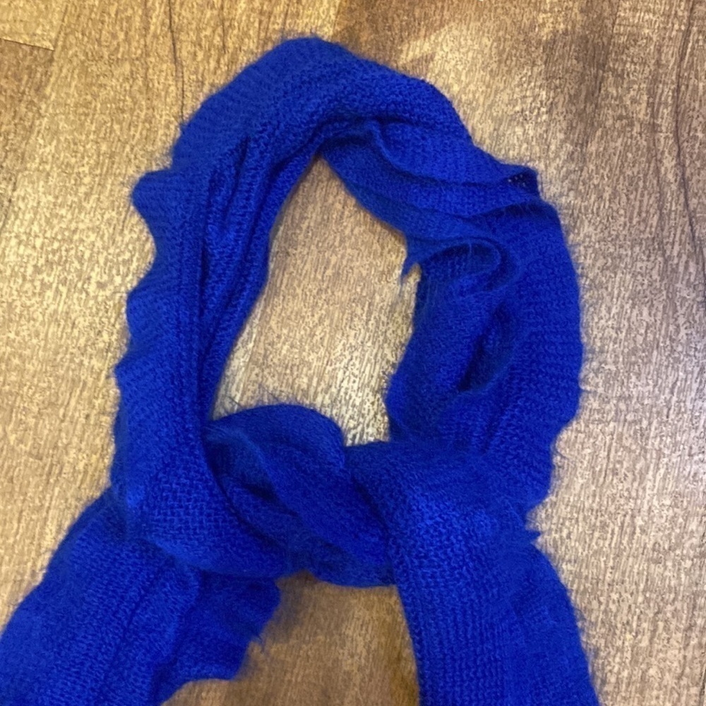 Blue cascading ruffle scarf with fringe on the ends
